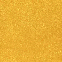 Gold paint on cement wall texture.