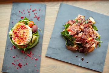 goat cheese and ham salads on stone plates