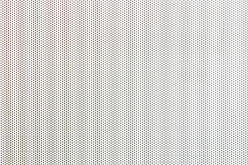 White metal plate with many small holes.