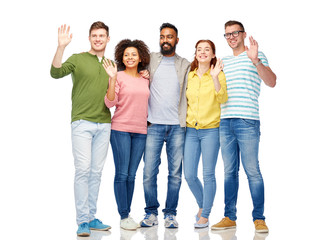 international group of happy people waving hands