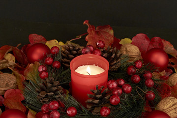 Candle with Christmas decorations around