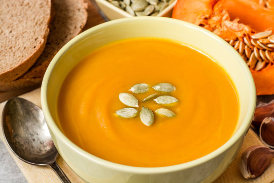 Pumpkin soup on gray stone background