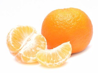 Ripe mandarin with leaves close-up on a white background.