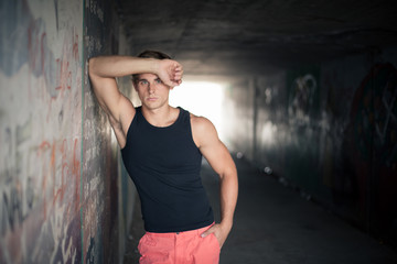 close up image of a good looking male model in a subway with gra