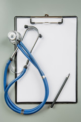 pen stethoscope and black clipboard