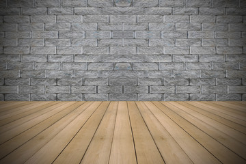 Wooden floor with colorful vintage stone wall background.