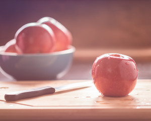 Red apple on cutting board