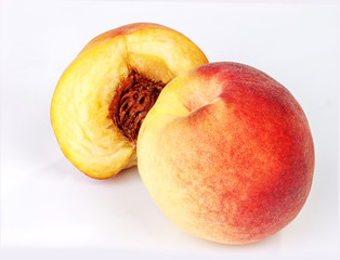 peach fruit whole and half on white background