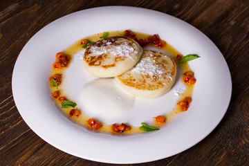Soft, delicate cheesecake with sea buckthorn sauce