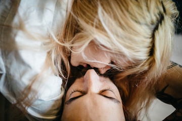 Close up portrait of a young couple kissing.