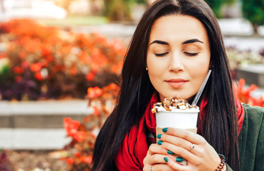 Long hair girl enjoying coffee dessert on the street