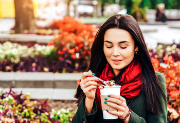 Long hair girl enjoying coffee dessert on the street