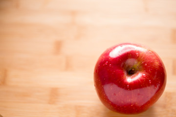 Red apple on cutting board