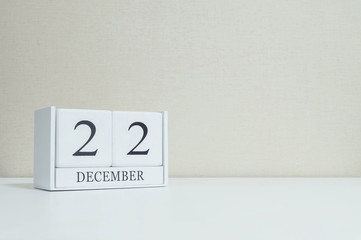 Closeup white wooden calendar with black 22 november word on blu