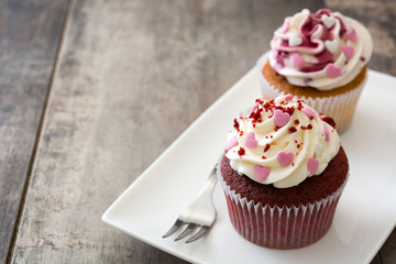 Valentine cupcakes decorated with sweet hearts on wooden table
