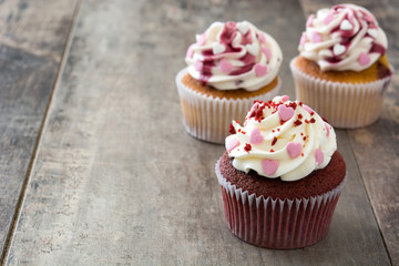 Valentine cupcakes decorated with sweet hearts on wooden table
