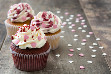 Valentine cupcakes decorated with sweet hearts on wooden table
