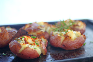 Roasted crushed potatoes on a metal pan with room for text