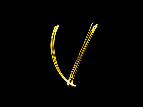 Sparkler firework light alphabet V (Capital Letters) at night ba