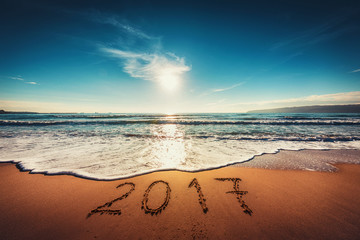 Happy New Year 2017 concept on the sea beach; sunrsie shot