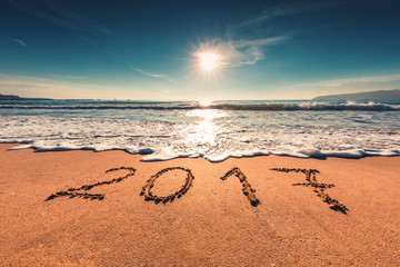 Happy New Year 2017 concept on the sea beach; sunrsie shot