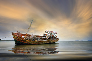An old shipwreck or abandoned shipwreck. , Wrecked boat abandoned stand on beach or Shipwrecked off...