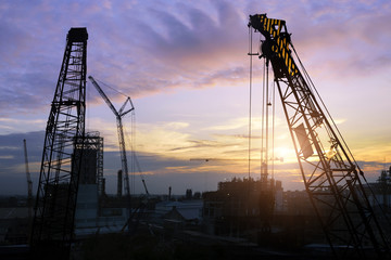 Construction site .Silhouette structural steel beam build large residential buildings at construction site .