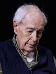 Portrait of an elderly person, on black background