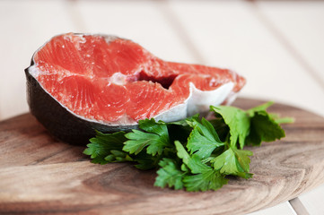 Raw salmon steaks on the wooden board