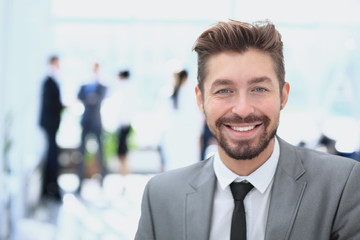 Handsome Business man in an office with blurred  background