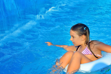 Real toddler girl at swimming pool