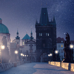Prague, Czech Republic. Charles Bridge with its statuette at night, Old Town Bridge Tower in the...