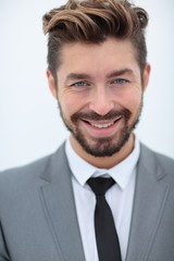 Close up portrait of a smiling handsome business man  over white