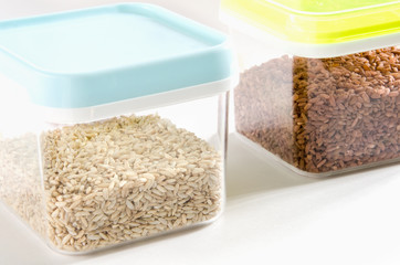 Food storage. Food ingredients (wild and brown rice) in plastic containers. Selective focus.