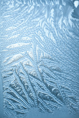 Frosty patterns on glass in winter