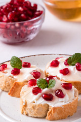 bread with cream cheese and pomegranate