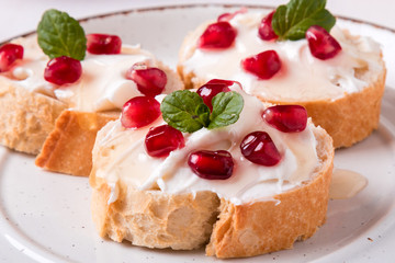 bread with cream cheese and pomegranate