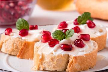bread with cream cheese and pomegranate