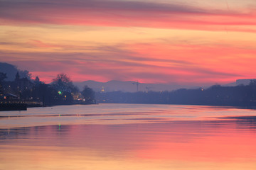 Pink sunset reflected in the Saone river in the city of Lyon.