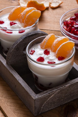 yogurt with pomegranate seeds and mandarin orange