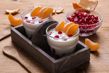 yogurt with pomegranate seeds and mandarin orange