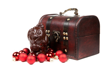 Chocolate Rooster and christmas red balls isolated on a white