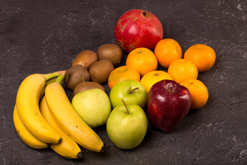 Fresh fruits on black texture background