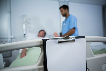 Clipboard hanging on bed in hospital