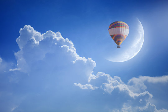 Hot air balloon rise up into blue sky. Dream come true concept.