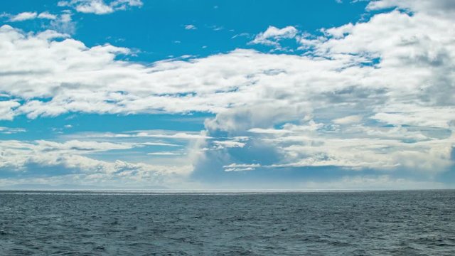 Cruising At Sea in a South American Moving Oceanscape with White Clouds in a Blue Sky