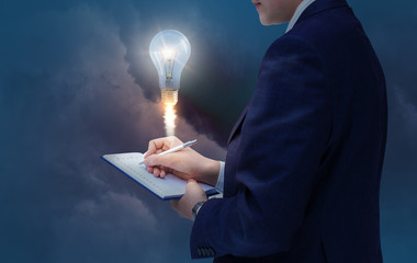 Businessman writes down the idea. New stsrt up.