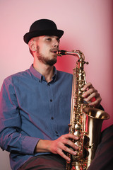 young saxophonist playing saxophone 