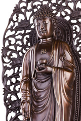 Fototapeta na wymiar Figure of the standing Buddha with a lotus in a hand and a swastika on a breast.