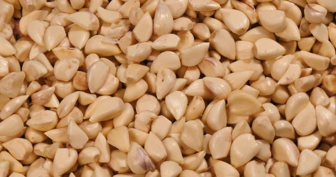 Top view of peeled garlic in rotation